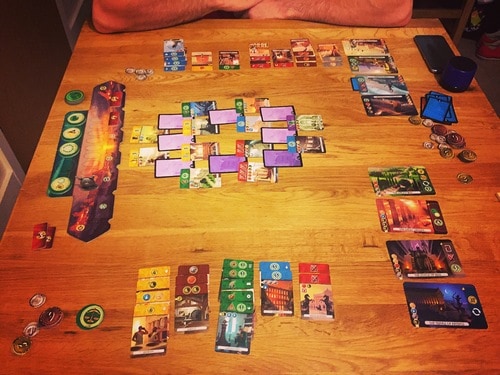 In 7 Wonders: Duel, players choose which cards to acquire, but must earn them by having the correct resources and race to them before their opponent. Image from Board Game Geek.